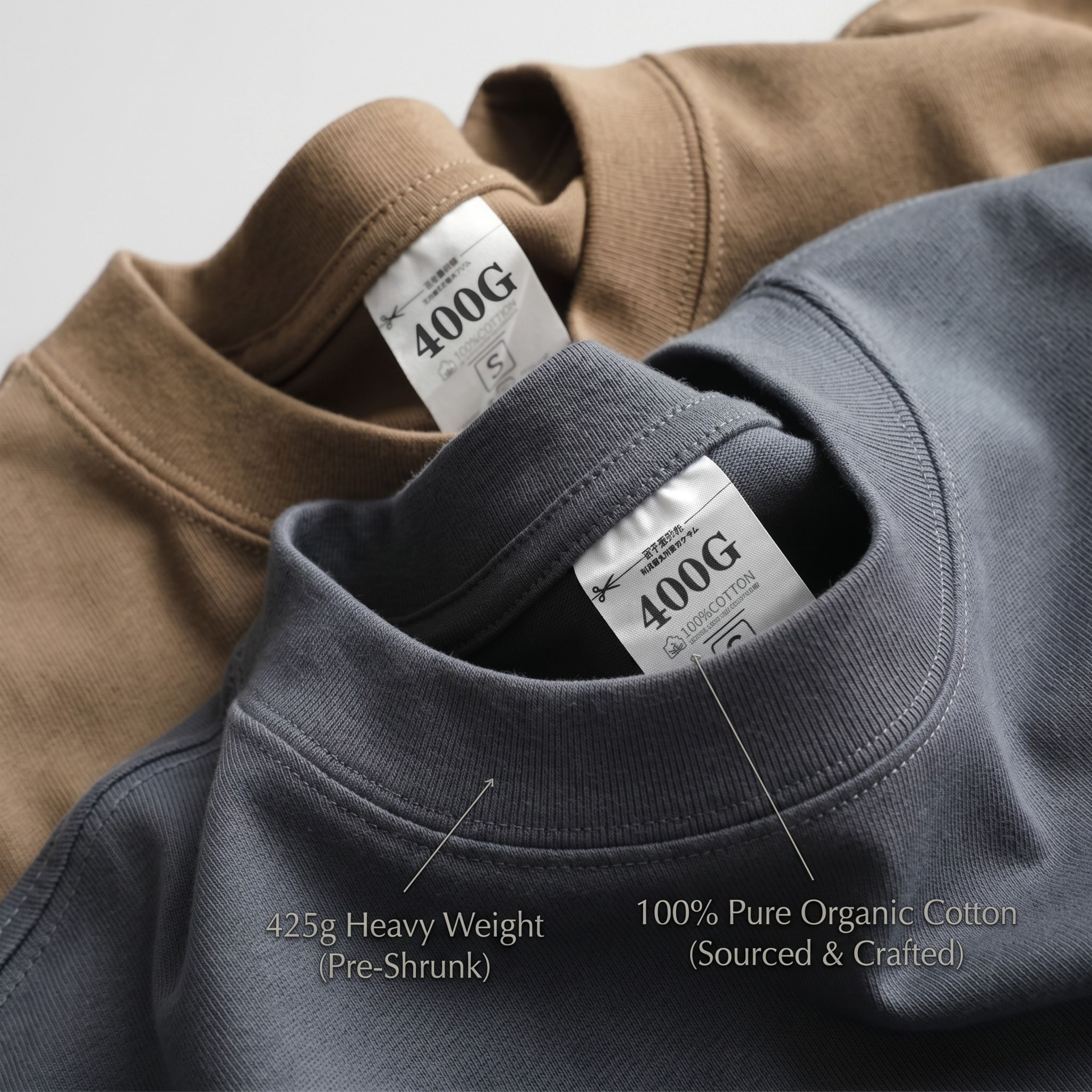 A stacked macro detail of the dark grey and khaki beige cotton t-shirts, showcasing the clean ribbed crewneck lines and fabric tags