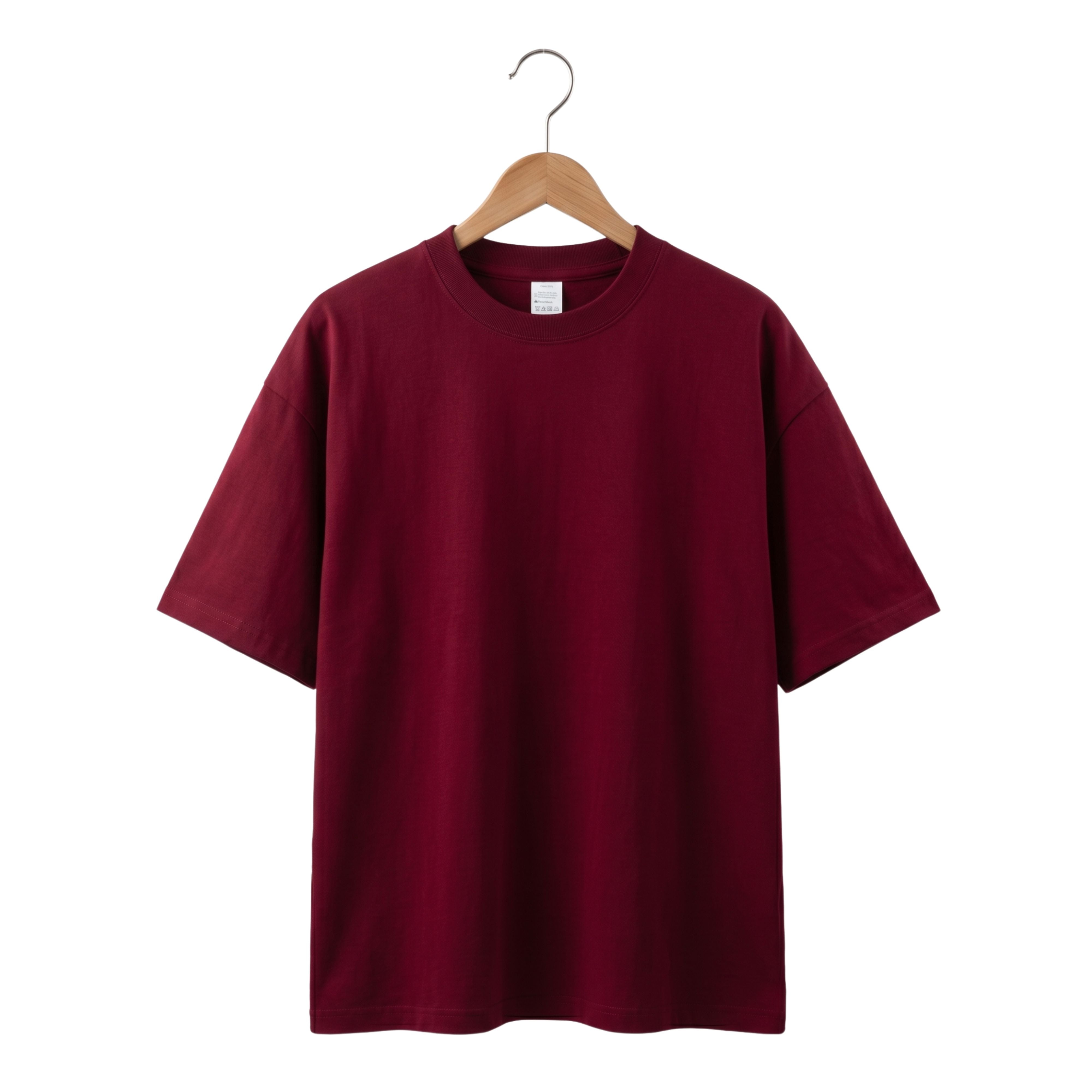 Oversized men's heavy knit cotton t-shirt in rich burgundy wine red hanging against a clean white studio background