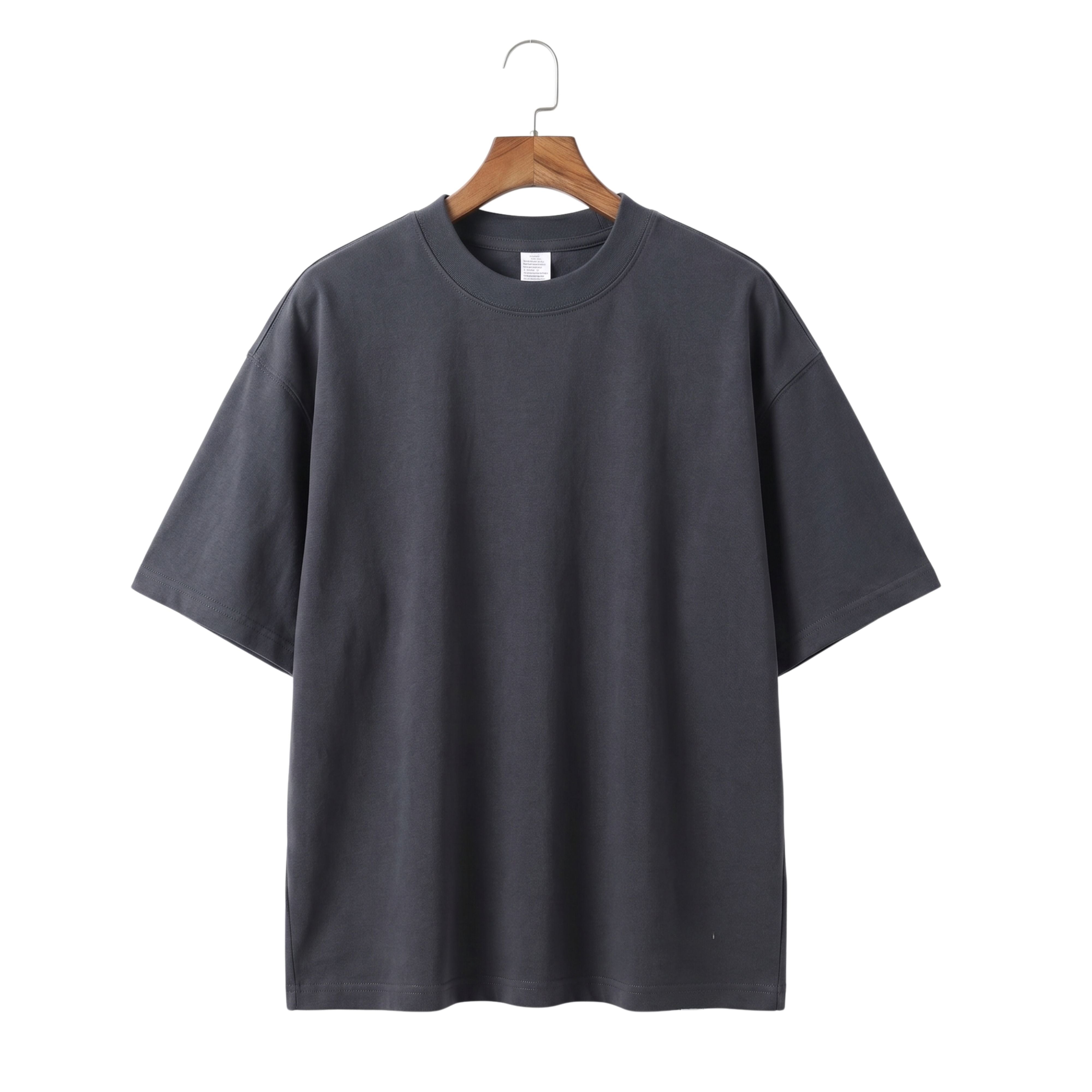 Blank drop-shoulder style men's casual t-shirt in dark charcoal grey hanging on a wooden coat hanger
