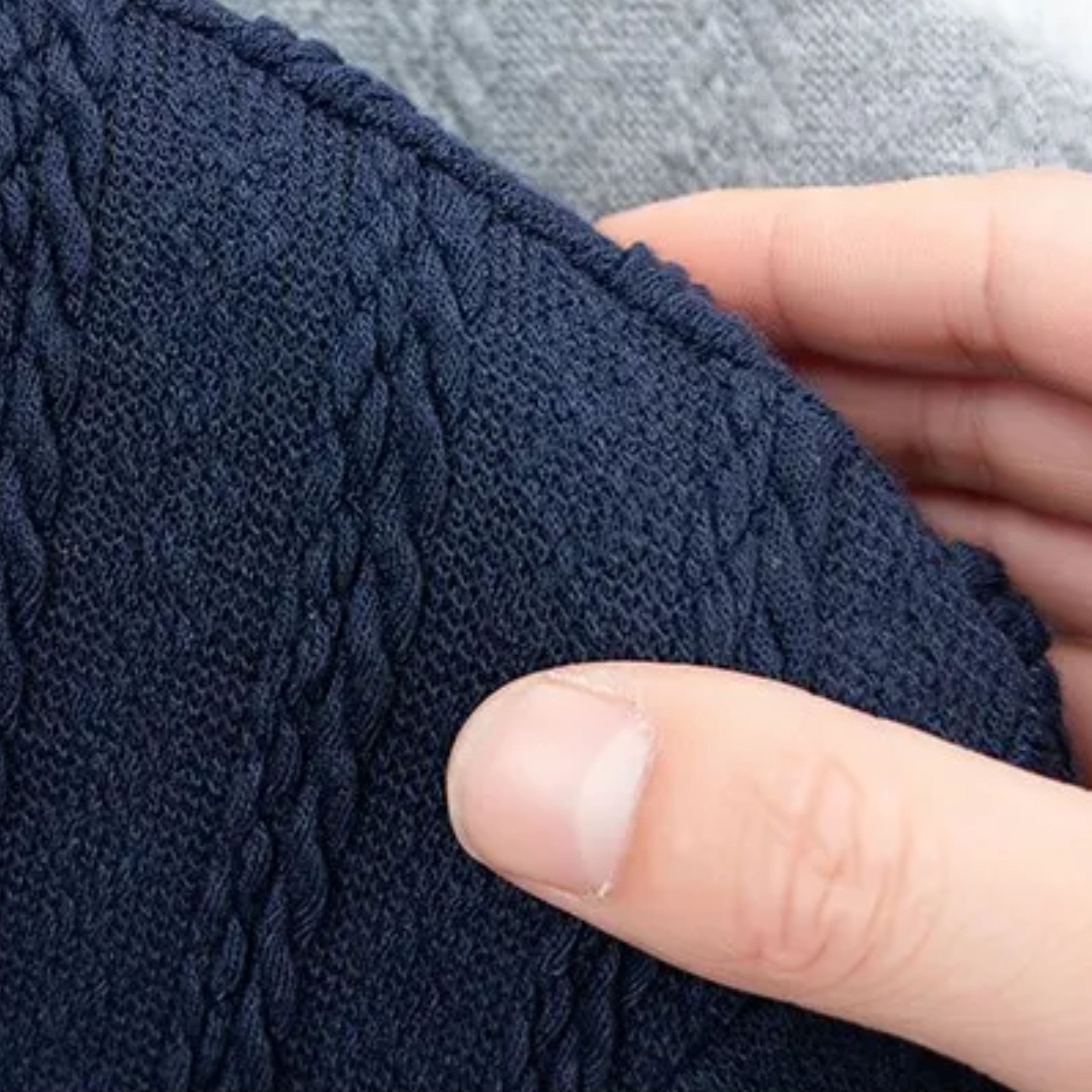 Close-up shot of the architectural geometric jacquard cable knit pattern and premium fiber finish