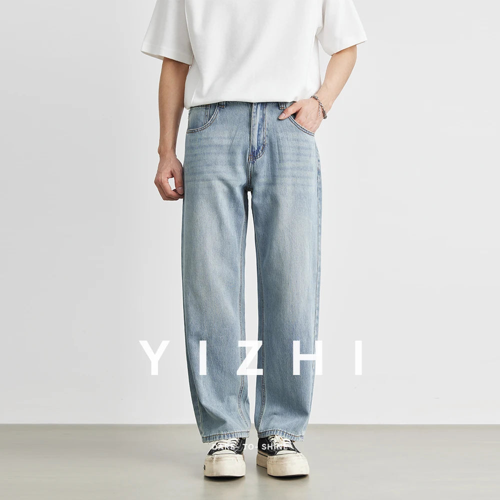 Full front view of a male model styling the ankle-length nine-point loose straight jeans with a minimalist white t-shirt