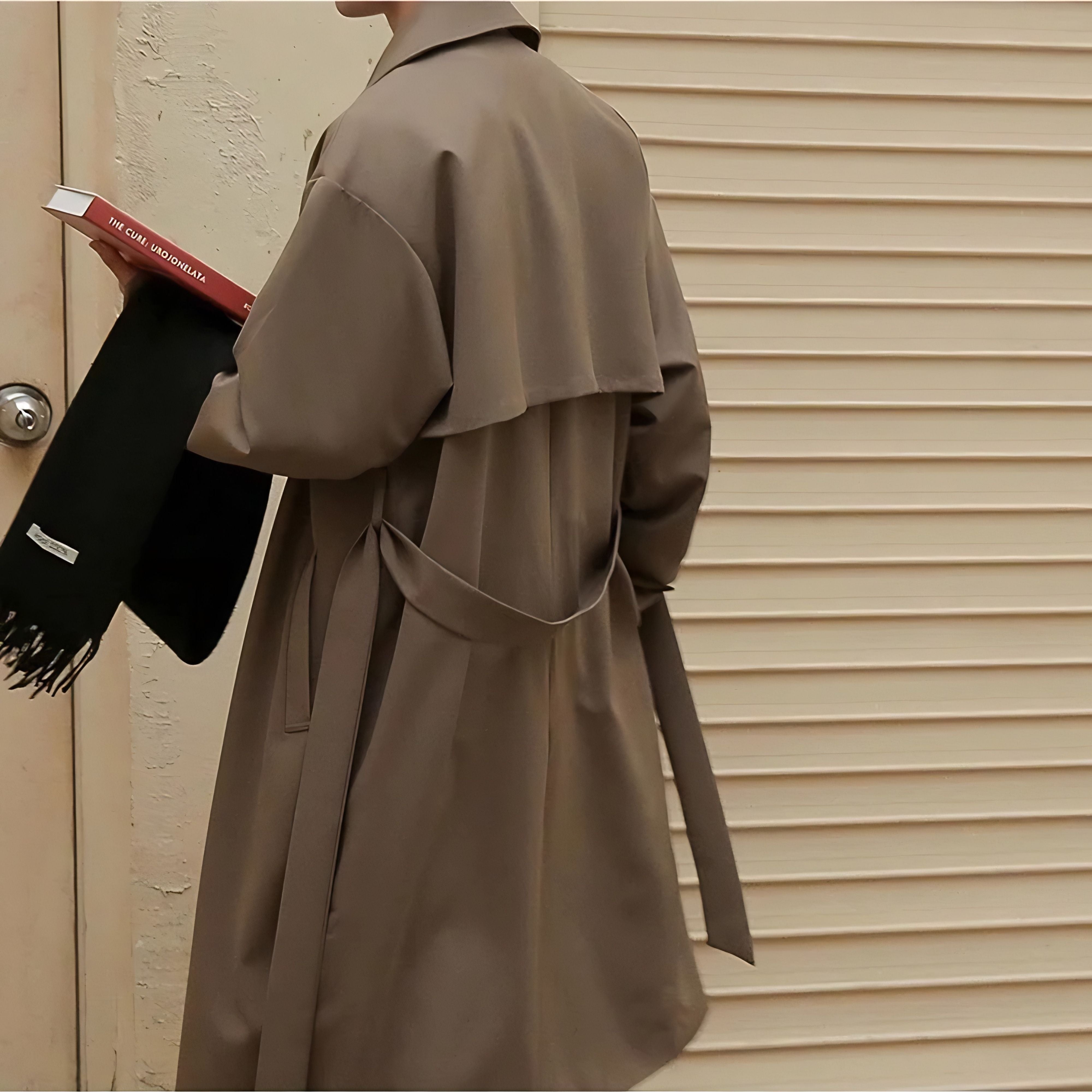 Back side view of man wearing loose mid length casual overcoat jacket in khaki brown