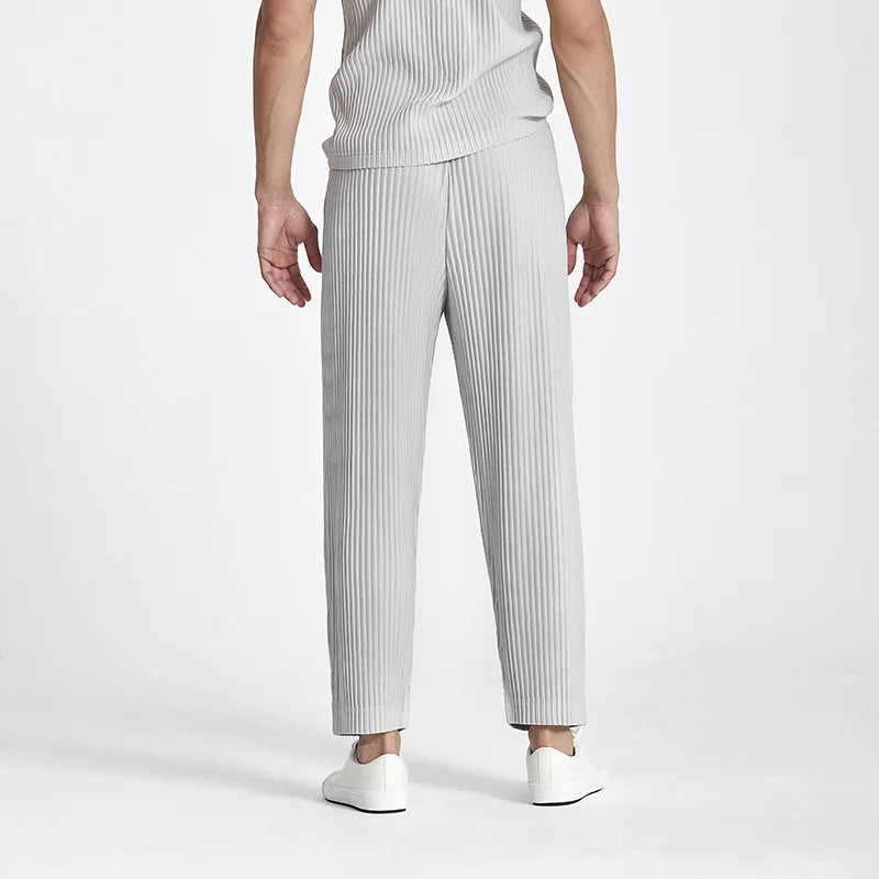 Back view of the straight loose draped silhouette of men's grey ice silk casual trousers