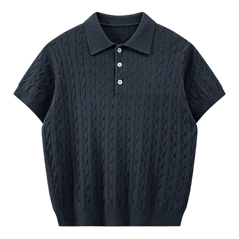Front view of a deep navy blue men's short-sleeve cable knit polo shirt with contrast light buttons.