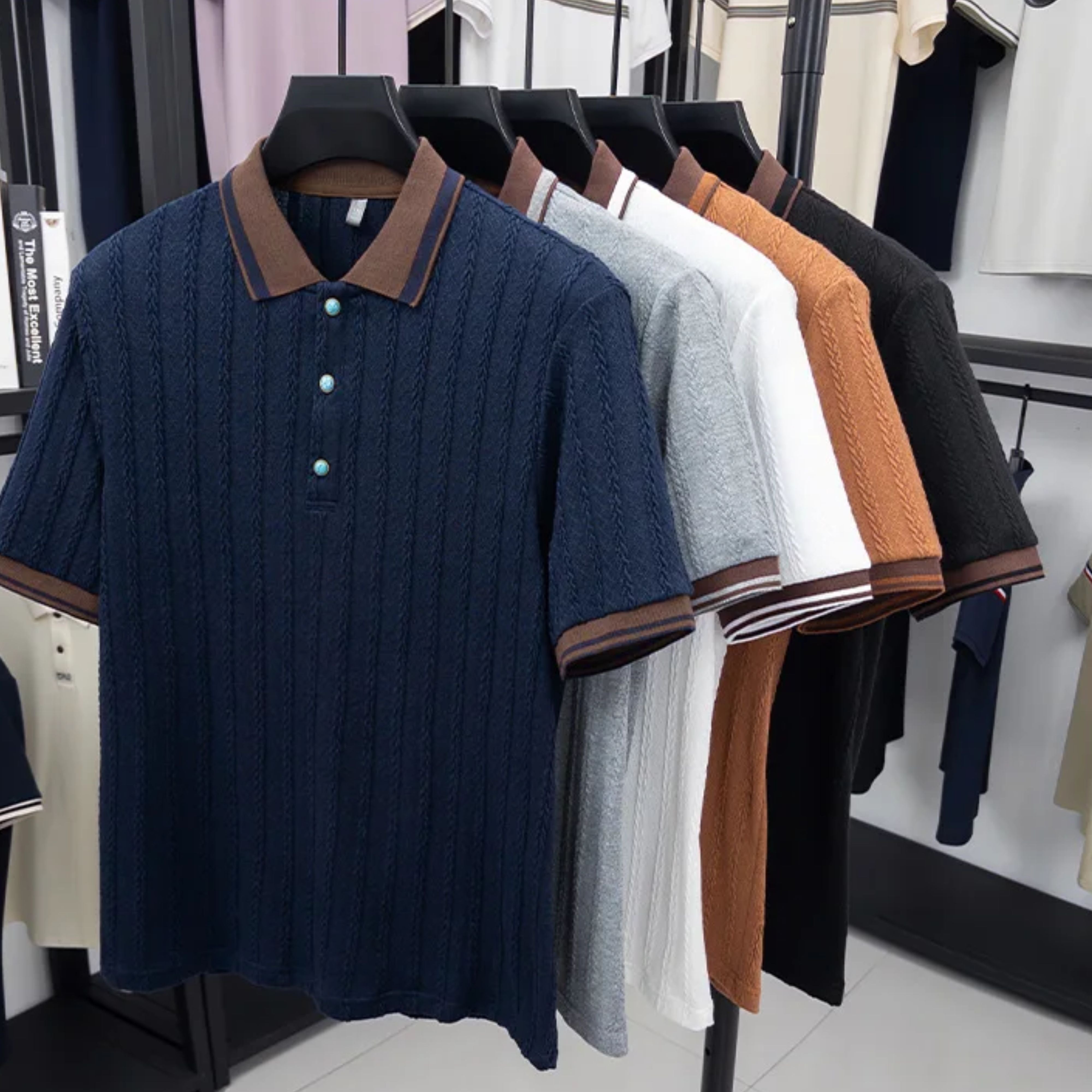 Showroom clothing rack display featuring the full collection of contrast color-blocking jacquard polo shirts.