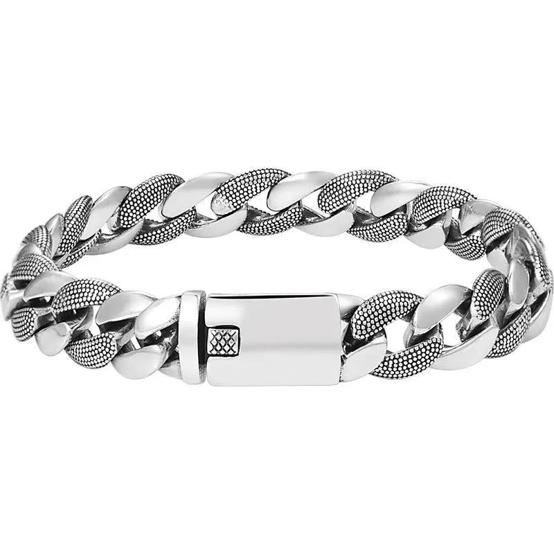 Men's chunky silver Cuban link bracelet featuring alternating smooth and textured links with a solid box clasp on a white background.