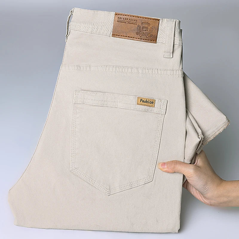 Close-up rear view of the khaki slim straight jeans, highlighting the clean five-pocket architecture, slight stretch fabric drape, and small branded back pocket label