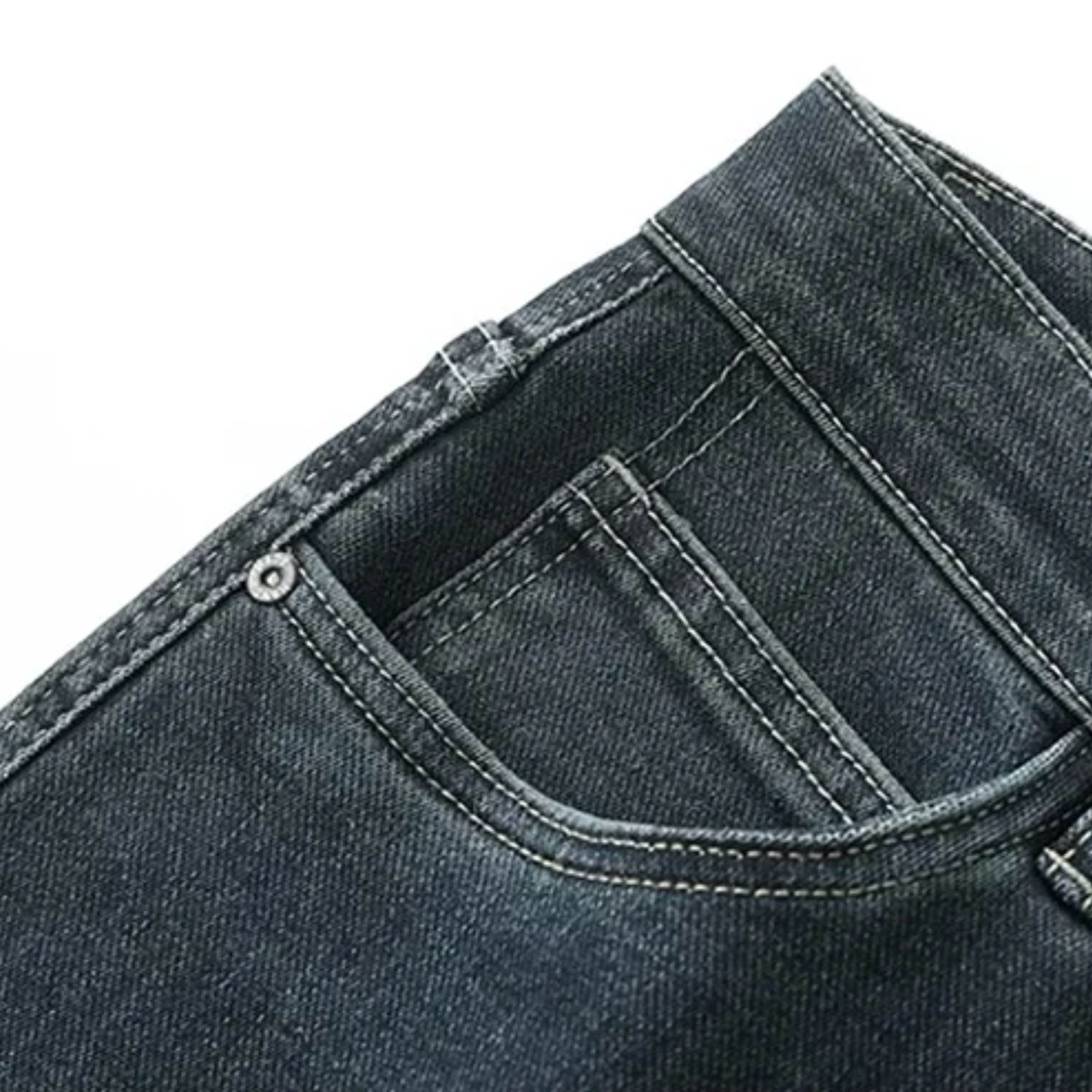 Close-up display of the classic front scoop pocket and integrated watch pocket on the sand-washed stretch denim, showing the metallic rivet detail