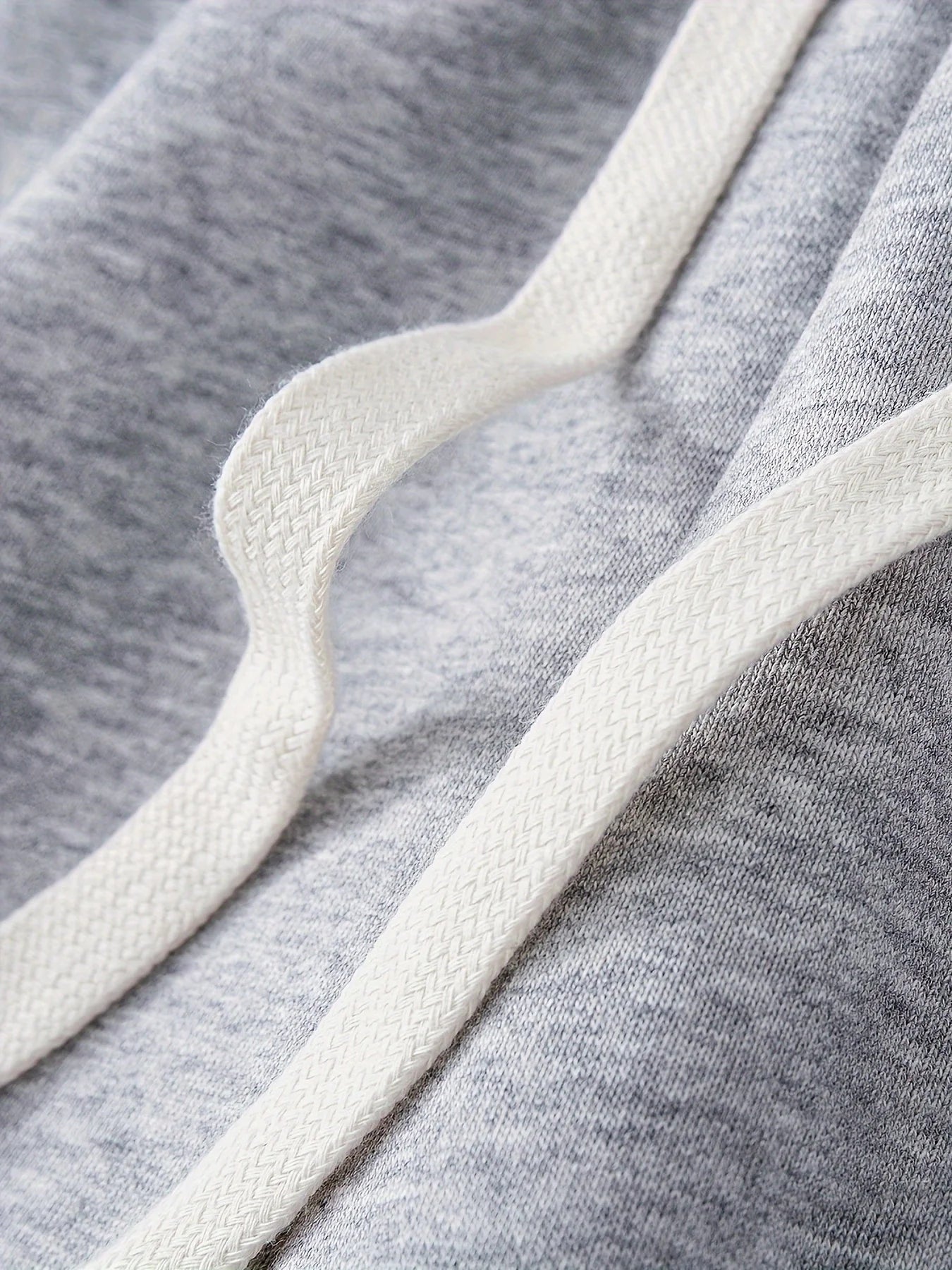 Close-up view of the white flat woven drawstring on the heather grey elastic waistband, highlighting the premium soft tatting weave fabric