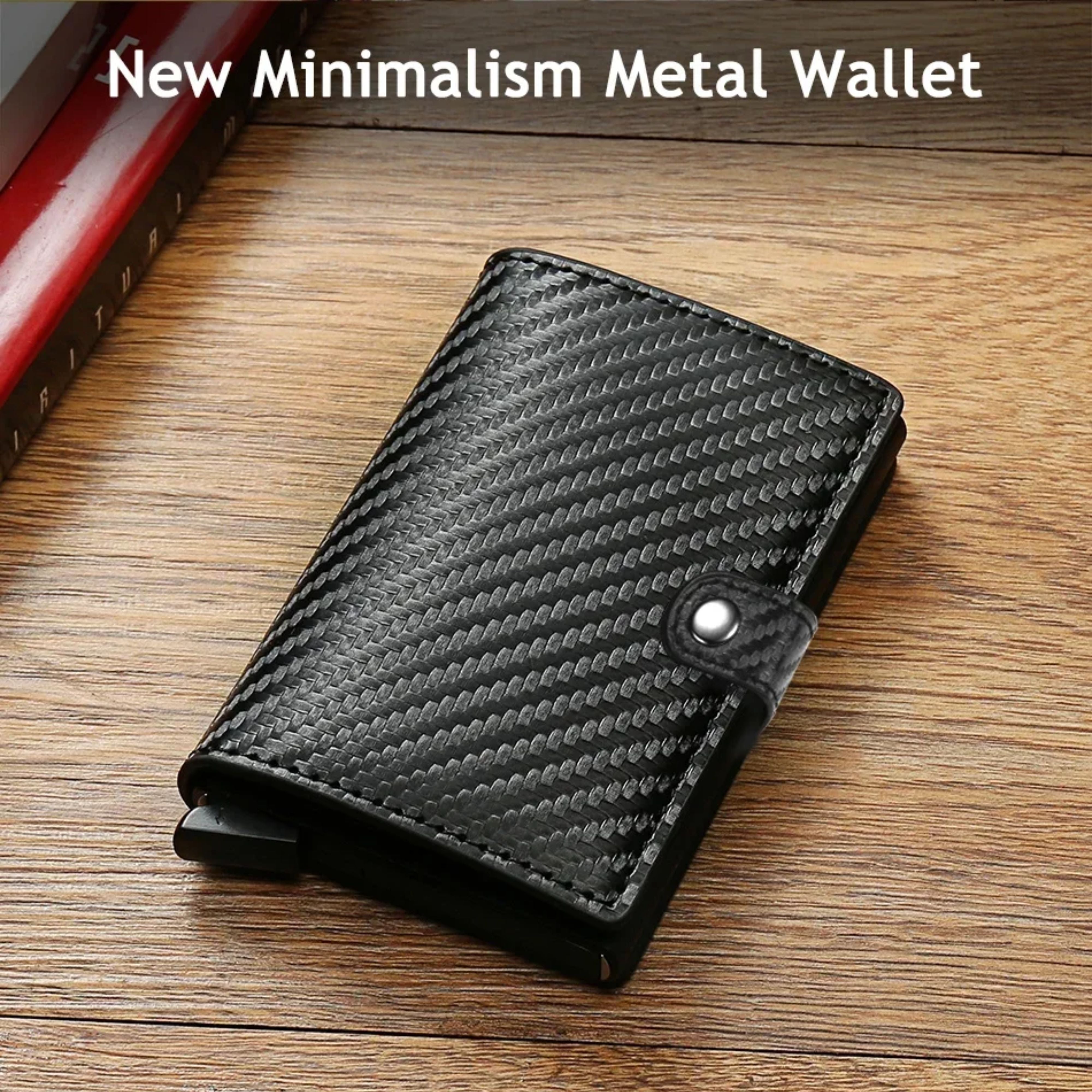 The black carbon fiber textured metal wallet sitting flat on a rustic wooden table background, captioned New Minimalist Metal Wallet