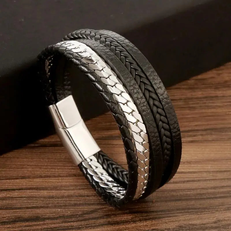 Black leather bracelet on wooden surface – The Crew