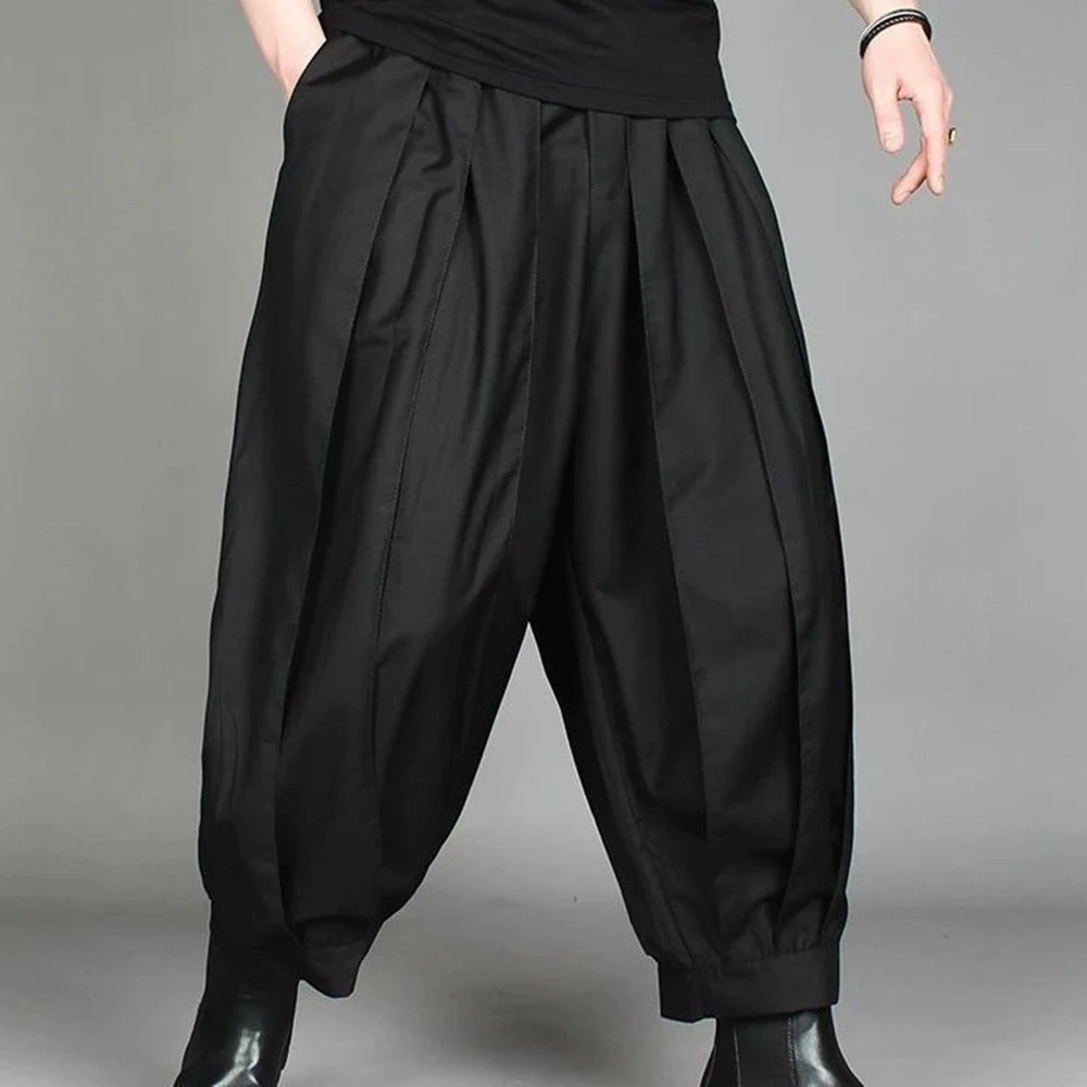 Model wearing men's black wide-leg harem trousers showing the relaxed casual streetwear drape