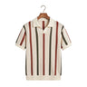 Front studio view of a men's short-sleeve hollow-out knit polo shirt with vertical stripes on a wooden hanger
