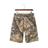 Front studio view of men's camouflage cargo denim shorts featuring a matching belt on a wooden hanger