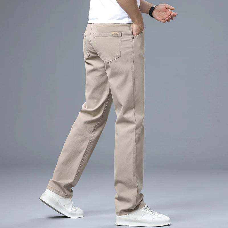Studio product presentation showcasing a male model wearing the solid black regular fit denim pants, including inset boxes detailing the waistline and rear pocket layout