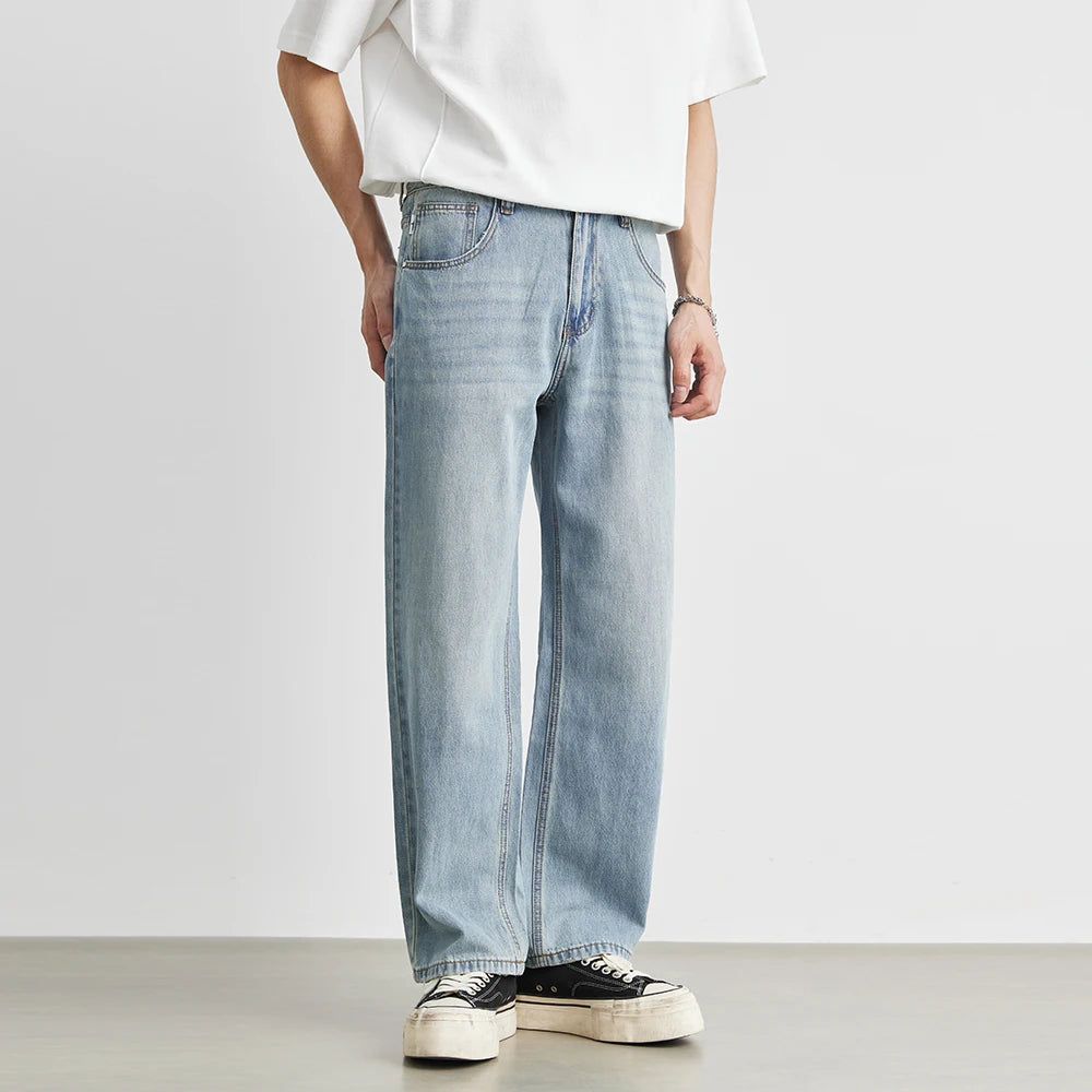 Front lifestyle view of a model showcasing the casual streetwear drape and roomier thigh fit of the cotton-lyocell blend wide-leg pants