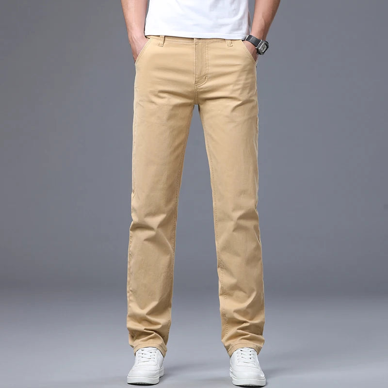 Front crop view of a model presenting the classic khaki straight leg jeans, highlighting the clean structural midweight drape