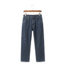 Men's Tsingyi Vanguard loose straight stretch jeans in a classic medium blue sand wash hanging on a wooden hanger