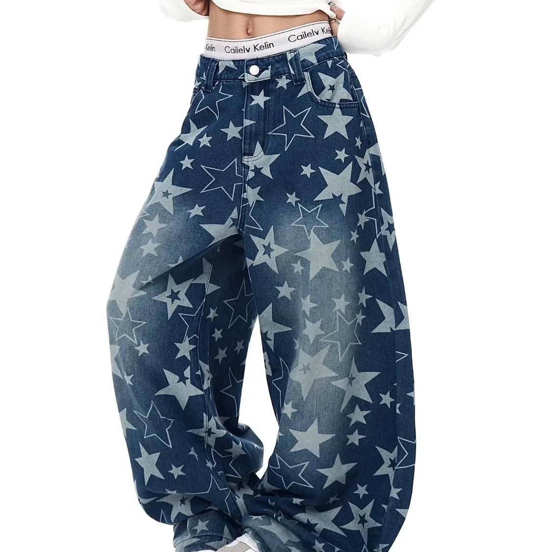 Model styling a bold urban streetwear look in blue baggy jeans featuring an all-over vintage star pattern