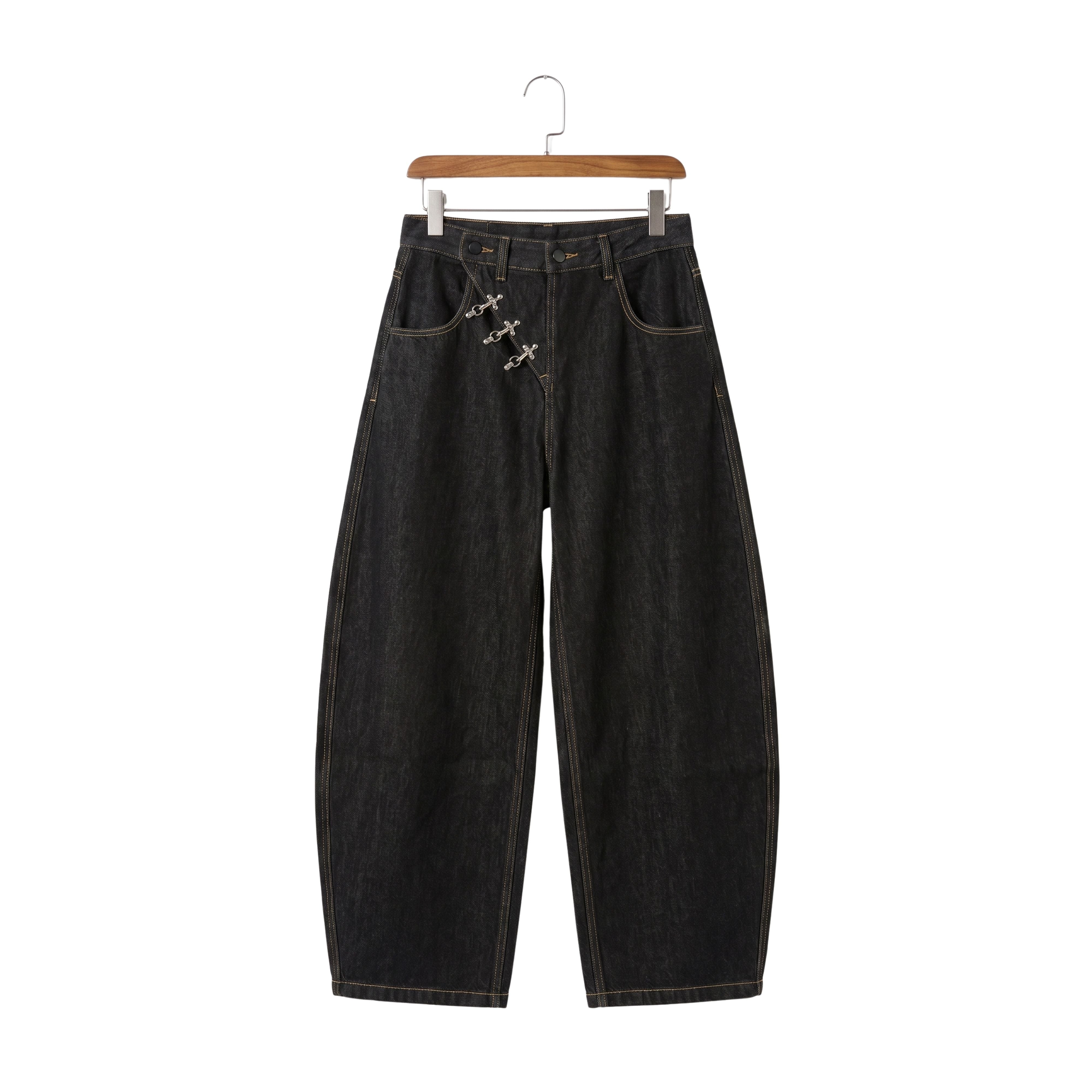 Washed black oversized streetwear trousers featuring raw metal buttons on the front pockets and a heavy rigid structure