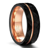 Tigrade tungsten carbide wedding band for men and women featuring a black hammered faceted exterior, an offset rose gold groove stripe, and a polished rose gold interior